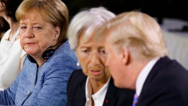 German Chancellor Angela Merkel watches as President