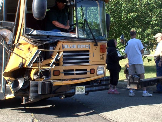 Brick school bus crashes into dump truck