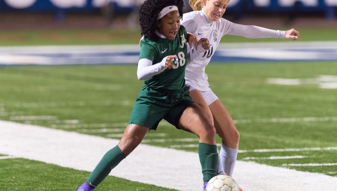 Rammie Noel battles with Taylor Tucker for control as Acadiana and STM meet for girls soccer at Cougar stadium.  Monday, Jan. 29, 2018.
