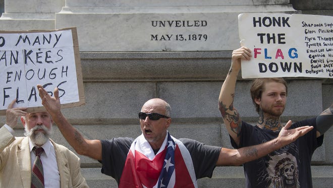 Pro-confederate flag demonstrator William Wells (C) chants "heritage not hate" next to an anti-confederate flag demonstrator (R) outside the South Carolina State House in Columbia, South Carolina last week.