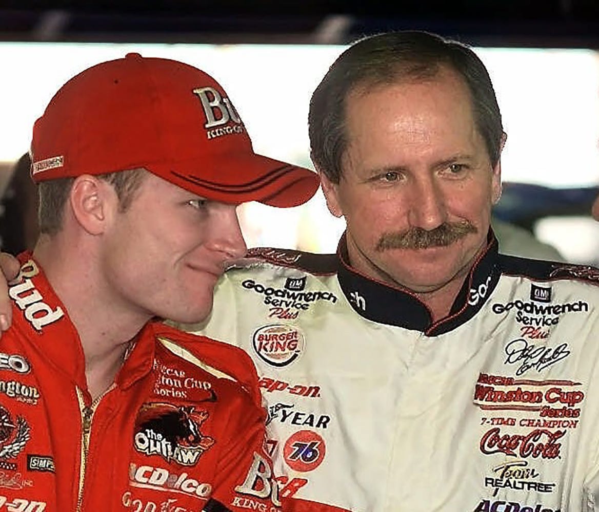 Dale Earnhardt, center, of Kannapolis, NC., has his arm around his son Dale Earnhardt Jr., left, as they talk with Daytona 500 pole sitter Dale Jarrett, of Hickory, NC.,  before practice Wednesday afternoon Feb. 16, 2000 at the Daytona International 