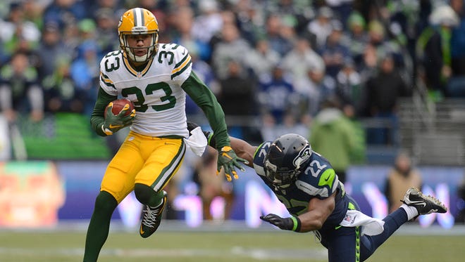 Green Bay Packers' Micah Hyde tries to elude Seattle Seahawks' Robert Turbin (22) while returning a punt in the during 2015 NFC Championship game at CenturyLink Field in Seattle.