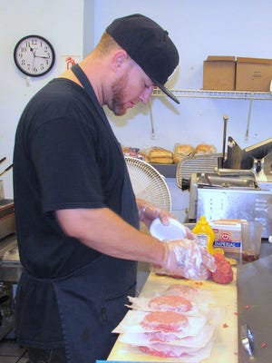 Cook Justin Wright makes burger patties at Honey B's Cafe in Horseheads.  All of the dishes on the menu are homemade, owner Winnie Bennett said.