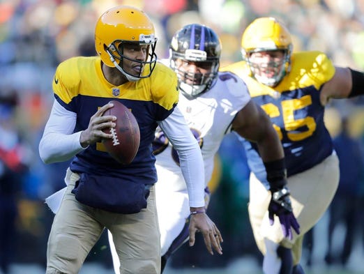 Green Bay Packers quarterback Brett Hundley (7) scrambles