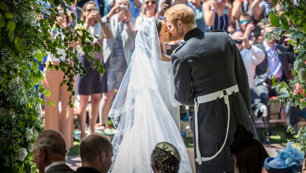 Prince Harry, Duke of Sussex kisses his wife Meghan,