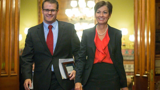 Iowa Gov. Kim Reynolds, right, enters the governor’s formal office  on Thursday, May 25, 2017, with Adam Gregg, the state’s public defender, after appointing him acting lieutenant governor.