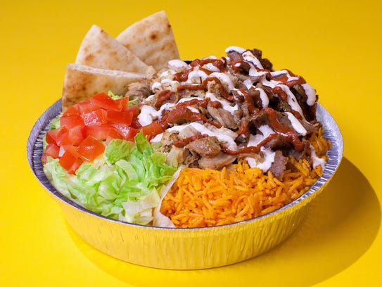 Halal Guys platter: halal meats, rice, white sauce, street food carts