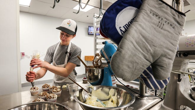 Assumption High School student Emie Dunagan decorates cupcakes at Chef Space.  She's had her own business since she was 15 and now fills orders for Heine Brothers shops around the city.  She's trying to buy a food truck.April 1, 2016