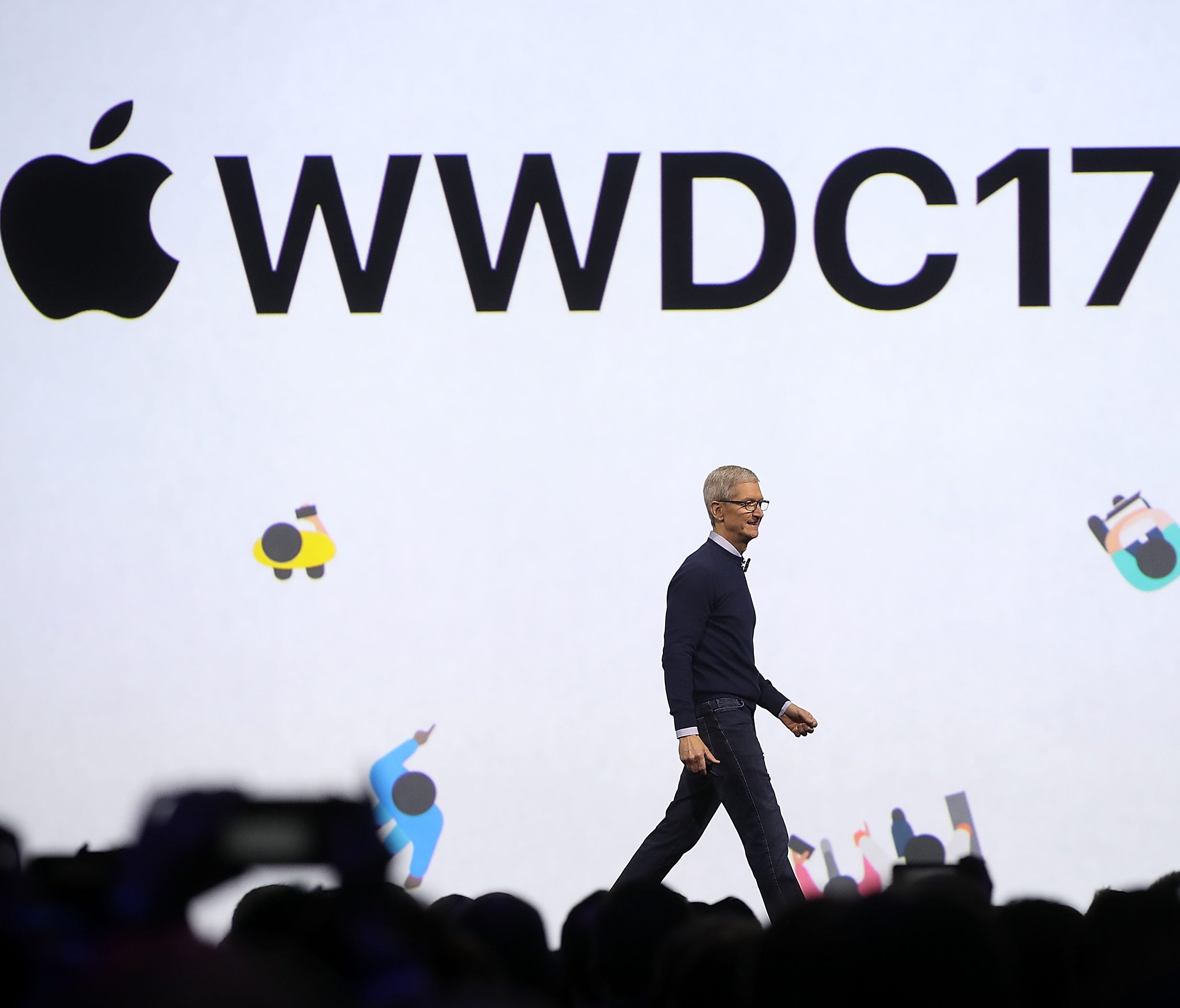 Apple CEO Tim Cook walks on stage to deliver the opening keynote address at the 2017 Apple Worldwide Developer Conference (WWDC) at the San Jose Convention Center on June 5, 2017, in San Jose, California. Apple CEO Tim Cook kicked off the five-day WW