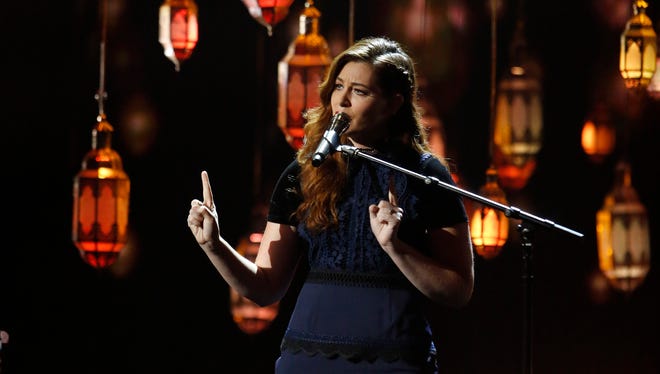 Mandy Harvey has a sign language interpreter onstage for her judge critique, and sometimes signs as she sings.
