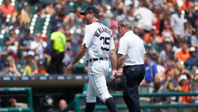 Tigers pitcher Justin Verlander leaves the game with trainer Kevin Rand in the third inning against the White Sox in Detroit, Sunday, June 4, 2017.