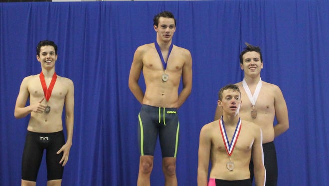 Glendale junior Henry Feyh (second from left) stands atop the podium at Foster Natatorium after taking first place in the 200-yard individual medley at the 2016 SW MO Swim and Dive Championships.