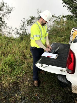 Mississippi Power engineer Matt Ball reviews work plans at his truck.