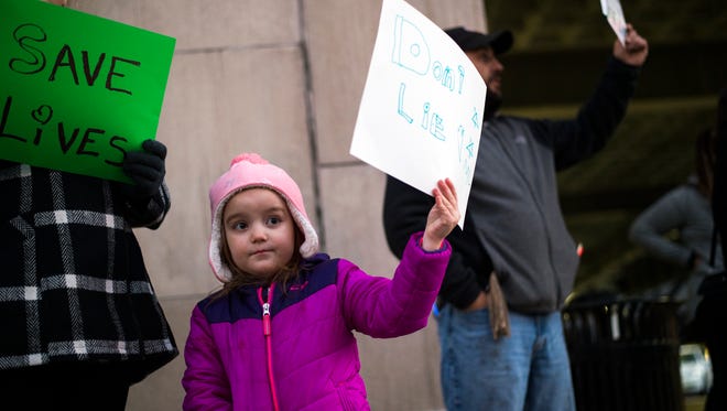 Madaline LaRose, 5, of Unadilla, holds a sign during a rally calling for increased government spending on heroin prevention and treatment held in front of the Broome County Office Building on Thursday, Nov. 12, 2015.