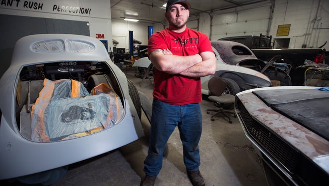 Jim Underhill, owner of East Coast Customz in Binghamton, poses for a photograph inside his shop on Tuesday, Dec. 29, 2015.