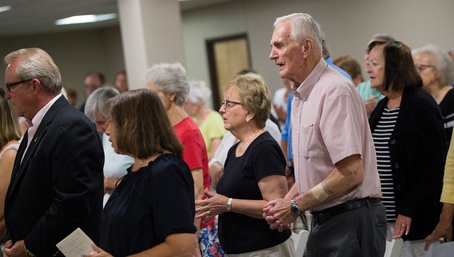 Endicott resident Jim McHugh, front right, sings during a "Year of Mercy" Mass at Catholic Charities of Broome County in Binghamton.