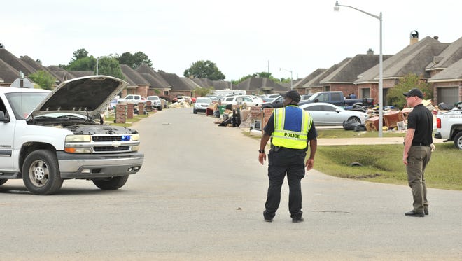 Police direct trafic in a flooded subdivision located in Youngsville, LA after the flood of 2016