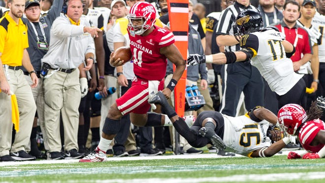 UL quarterback Anthony Jennings gains some yardage on this play, but it didn't happen often in Saturday night's 28-21 New Orleans Bowl loss to Southern Miss. Jennings was sacked six times.