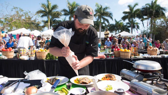 Chef Jake Reynolds, of the Pelican Cafe, puts the finishing touches on his competition plates during the third annual Stuart Chopped! competition at ArtsFest in Memorial Park on Feb. 12, 2017, in downtown Stuart.