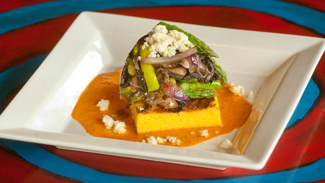 Cafe Lou Lou's blue cheese polenta, topped with grilled asparagus, portabella mushrooms and red onions, served atop a roasted pepper coulis. The restaurant soon will be rebranded 
as Lou Lou Food + Drink.