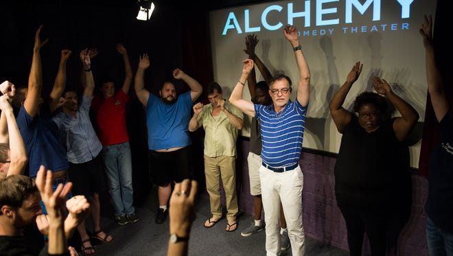 Participants of an Alchemy Comedy Theater improv class perform warmup exercises together during a class on Saturday, July 1, 2017. 