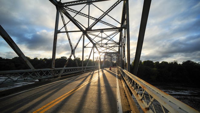The sun sets on the 1930's era Spottsville bridge Tuesday. State officials hope that a replacement for the functionally obsolete bridge will begin by late 2018 or early 2019, October 10, 2017.