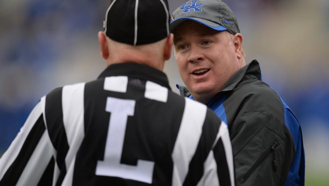 UK head coach Mark Stoops has some words with a referee during the second half of the University of Kentucky Wildcats Football game against Louisiana-Monroe in Lexington, KY. Saturday, October 11, 2014. 