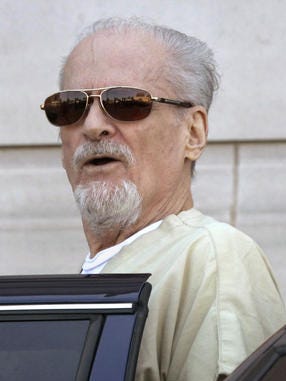 Evangelist Tony Alamo talks to reporters as he is escorted to a waiting police car outside the Federal Court House in Texarkana, Arkansas, after a day of jury deliberation in his trial Thursday, July 23, 2009.