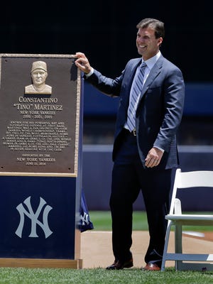 Former New York Yankees first baseman Tino Martinez stands next to a plaque that will be displayed at Yankee Stadium’s Monument Park.