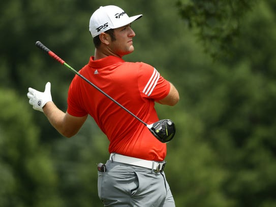 Jon Rahm reacts to his drive on the 10th hole during