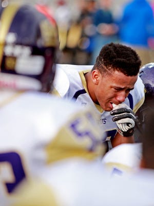 Waynesboro's Dominique Gray huddles with his team after the quarterfinal game on Saturday, November 29, 2014. The Little Giants lost to Western Albemarle, 28-33.