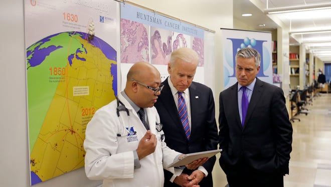 Dr. Jewel Samadder, left, speaks with Vice President Joe Biden as former Utah Gov. Jon M. Huntsman looks on during a tour of the research lab at the Huntsman Cancer Institute Friday, Feb. 26, 2016, in Salt Lake City, as part of the White House's cancer "moonshot," an ambitious effort to double the rate of progress toward curing cancer.