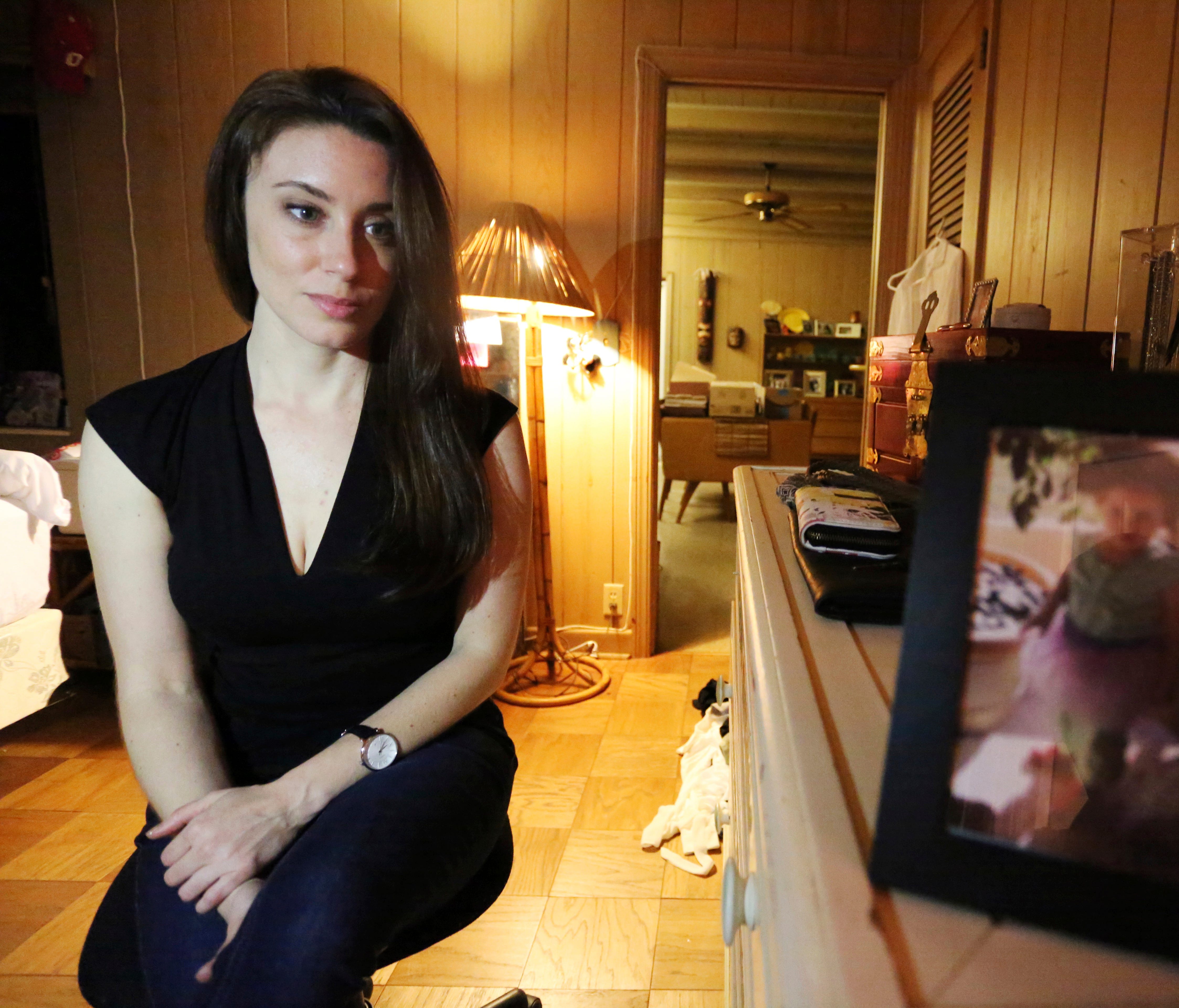 Casey Anthony poses for a portrait next to a photo of her daughter, Caylee, in her West Palm Beach, Fla., bedroom on Feb. 13.