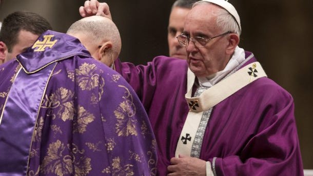 Pope Francis places ashes on the head of Cardinal Tarcisio Bertone during the Ash Wednesday mass on Feb. 10, 2016. 