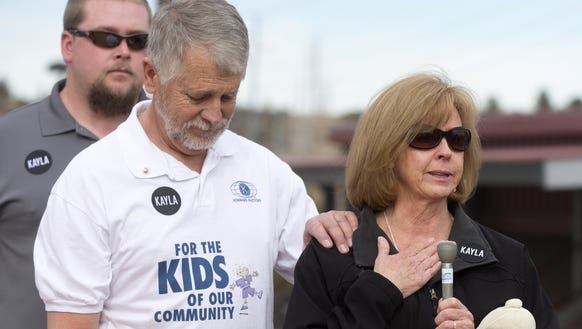 Carl Mueller and his wife, Marsha, speak during a playground