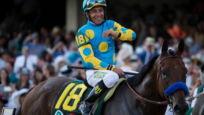 Jockey Victor Espinoza celebrates atop American Pharaoh after winning the 141st Kentucky Derby at Churchill Downs in Louisville, Ky. May 2, 2015.
