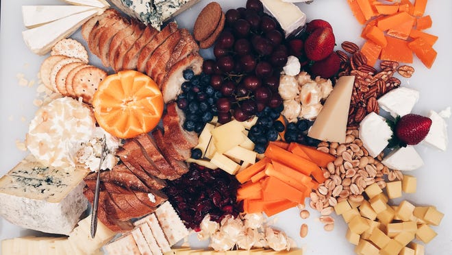 Offer fresh and dried fruits, a selection of nuts, crackers, pieces of bread, olives, honey and jams alongside the cheeses on your board.