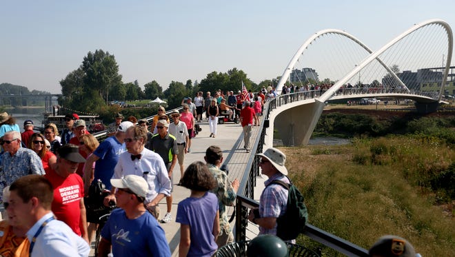 Hundreds of people parade across the Peter Courtney Minto Island Bridge during its grand opening celebration at Riverfront Park in Salem on Wednesday, Aug. 2, 2017.