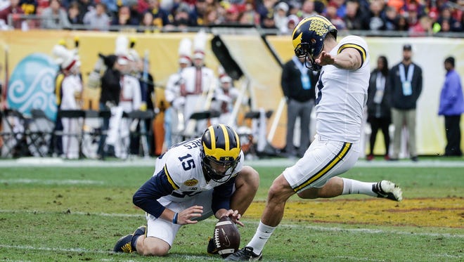 Michigan Wolverines kicker Quinn Nordin attempts a field goal as Garrett Moores holds during the first half of the Outback Bowl against South Carolina at Raymond James Stadium in Tampa, Fla., Monday, Jan. 1, 2018.