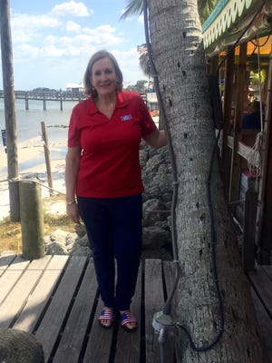 Cindy Geesey stands on the deck at Capt Hiram's, a Sebastian resort that donates to the Rest Relaxation & Romance program.