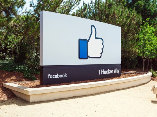 The Facebook thumbs up logo on the street sign at the entrance to its headquarters.