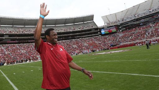 Avery Johnson waves to the crowd at Alabama's A-Day game Saturday at Bryant-Denny Stadium.
