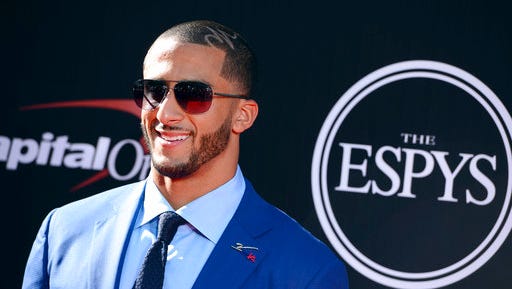 FILE - In this July 16, 2014, file photo, San Francisco 49ers' Colin Kaepernick arrives at the ESPY Awards at the Nokia Theatre in Los Angeles. Video and pictures from social media posted on May 1, 2017, show Kaepernick standing outside a New York City parole office with two boxes of custom-made suits. An Instagram post by Kaepernick’s “Know Your Rights Camp” campaign says the suits will make parolees “better equipped to achieve gainful employment” and “live more productive lives.”