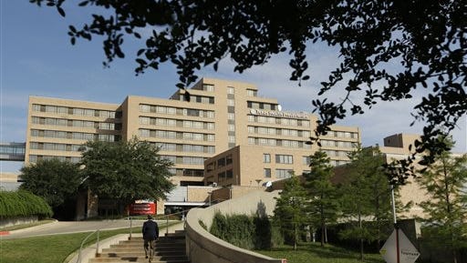 FILE - A man walks up the stairway leading to the Texas Health Presbyterian Hospital in Dallas, in this Tuesday, Sept. 30, 2014 file photo. The Texas health department statement Wednesday Oct. 15, 2014 said a second health care worker tests positive for Ebola. (AP Photo/LM Otero, File)