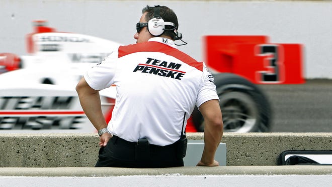 Castroneves flies by a team member during the race. Helio Castroneves won the 93rd running of the Indianapolis 500 was held May 24, 2009 at the Indianapolis Motor Speedway in Indianapolis, IN. (Sam Riche / The Indianapolis Star)
