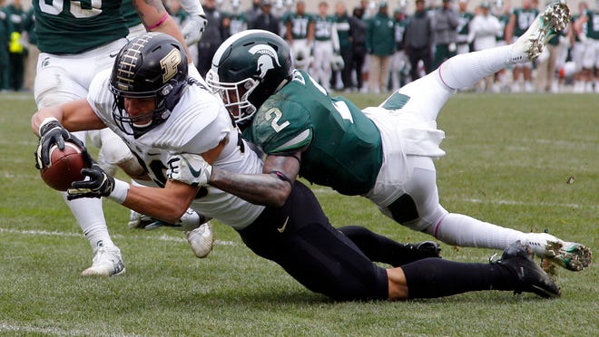 Purdue's Brycen Hopkins, left, dives for the goal line against Michigan State's Justin Layne (2) on a 30-yard pass reception during the third quarter of an NCAA college football game, Saturday, Oct. 27, 2018, in East Lansing, Mich. Hopkins was down short of the goal but Purdue scored on the next play. (AP Photo/Al Goldis)