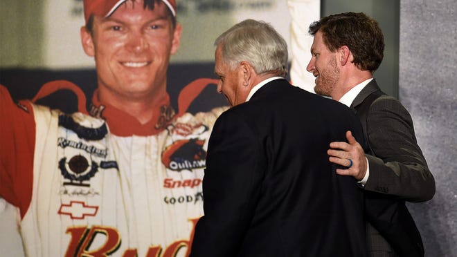 NASCAR driver Dale Earnhardt Jr., left, and team owner Rick Hendrick, right, put their arms around one another as they exit the stage following Earnhardt Jr. announcing his retirement at the end of the 2017 season on Tuesday, April 25, 2017 in Concord, N.C. (Jeff Siner/Charlotte Observer/TNS)