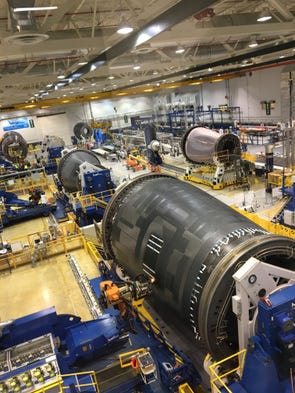 Portions of Boeing Dreamliner fuselages are worked