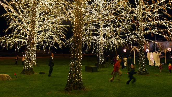 Children play under the trees wrapped in holiday lights during Gaylord Opryland Resort & Convention Center's lighting ceremony Thursday, Nov. 19, 2015. This is the resort's 32nd "A Country Christmas," which includes 2.3 million holiday lights.