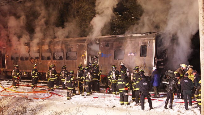 Firefighters work at the scene of a train vs car accident at the Commerce Street crossing in Valhalla Feb. 3, 2015.
